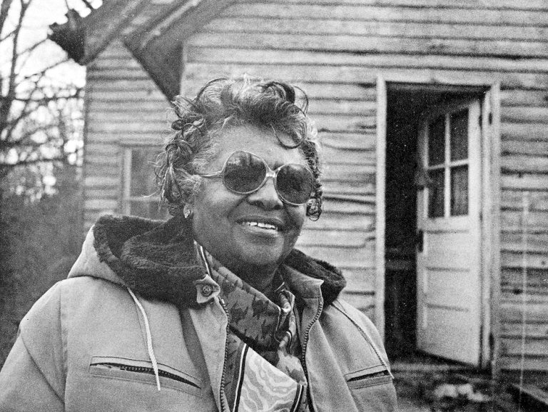 Elvare Gaskin in front of a one room school.